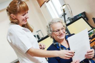Doctor looking at a piece of paper with a patient