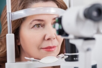 woman getting eyes examined
