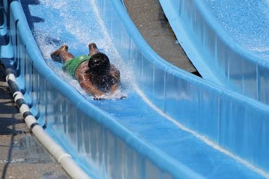 boy sliding down a water slide