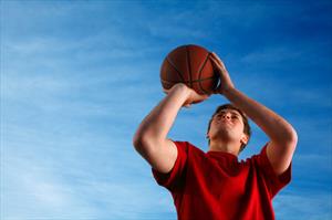 man shooting a basketball