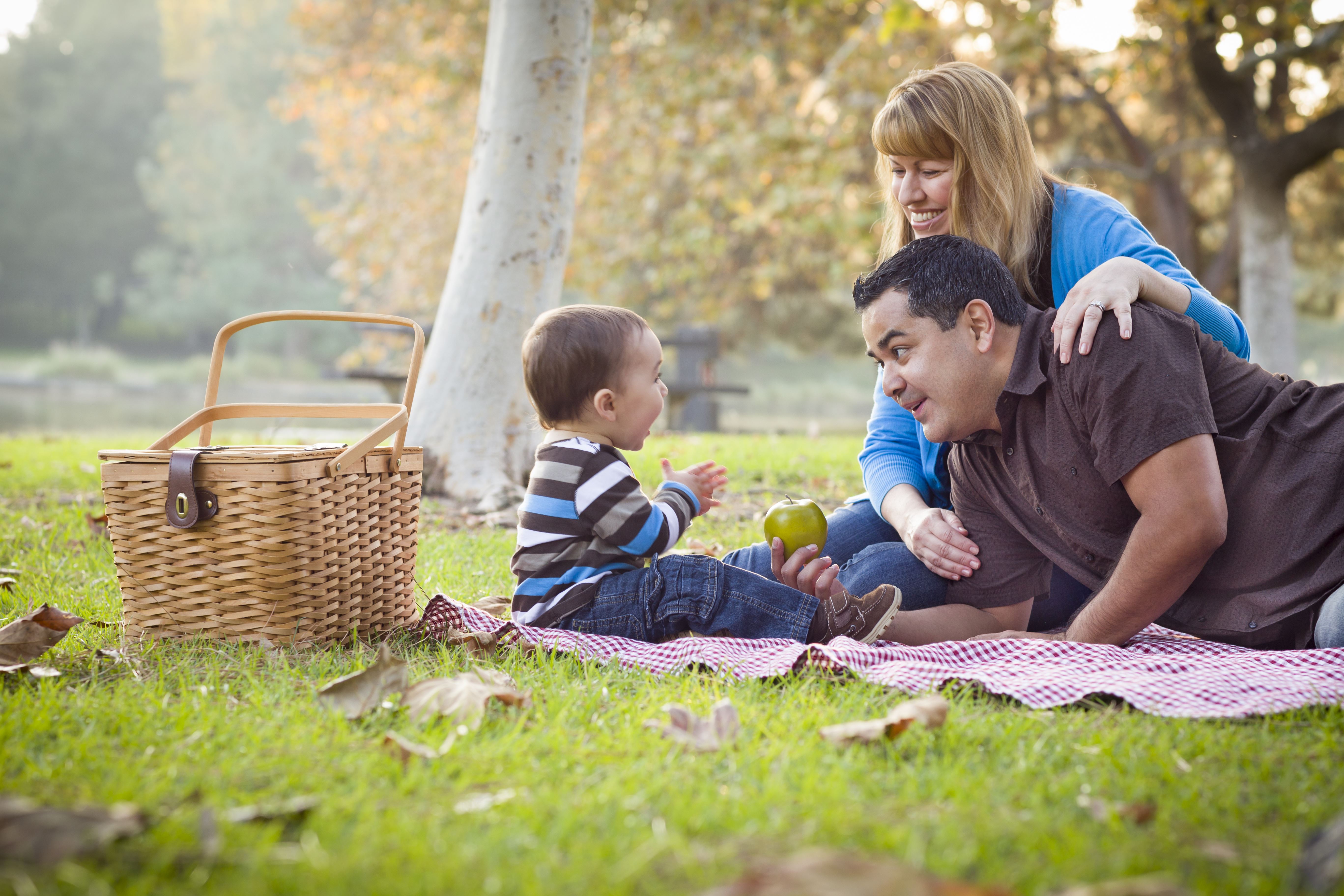 a mother and father with their son in the park