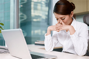 Woman with her hands on her nose