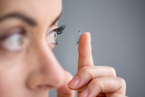 Woman putting a contact lens in